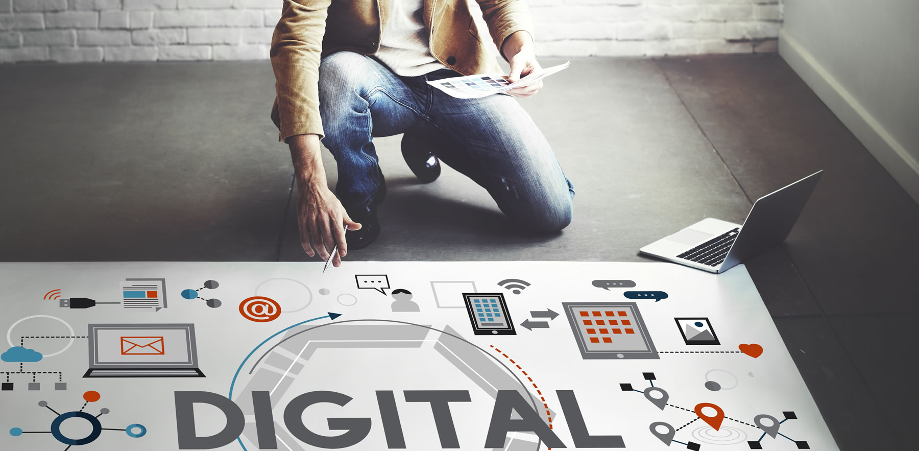 Man kneeling and looking at digital marketing strategy graphic - Marketing