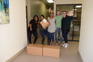 5 Academic Health Plans employees happy and celebrating the arrival of their packages