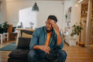 Young black man having pain and holding his head slightly