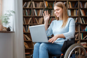 Student in wheelchair using telehealth for a mental health appointment